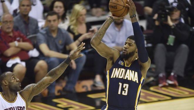 Indiana Pacers forward Paul George shoots against Cleveland Cavaliers forward LeBron James in the first quarter in game one of the first round of the 2017 NBA Playoffs.