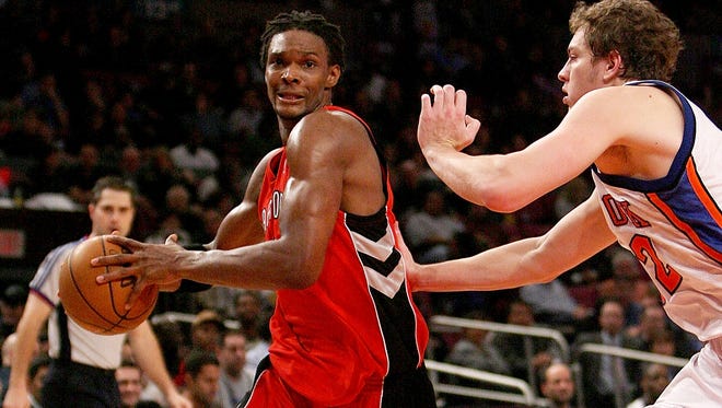 Chris Bosh of the Toronto Raptors drives to the basket against New York Knicks forward David Lee during a 2008 game at Madison Square Garden in New York City.