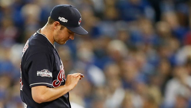 Cleveland Indians starting pitcher Trevor Bauer (47) looks at his bleeding finger during the first inning in game three of the 2016 ALCS playoff baseball series against the Toronto Blue Jays at Rogers Centre.