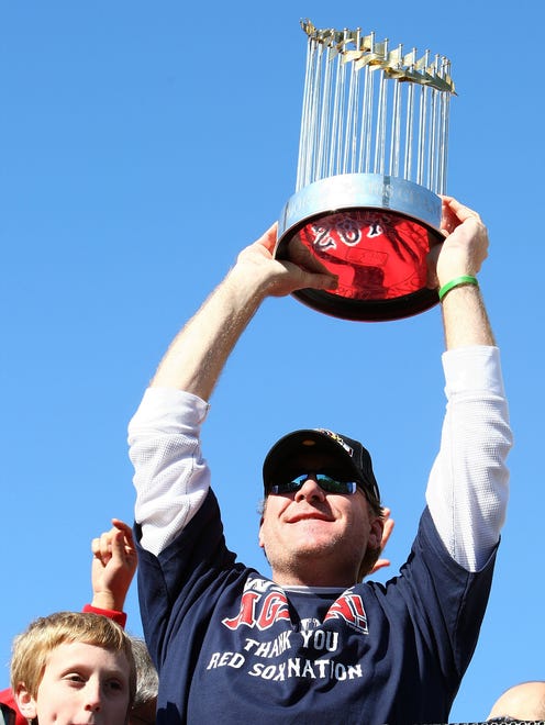 Schilling hoists the World Series trophy at Boston's parade in 2007.