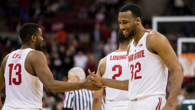 Ohio State Buckeyes center Trevor Thompson and guard JaQuan Lyle share a handshake near the end of the game against the Michigan State Spartans at Value City Arena.