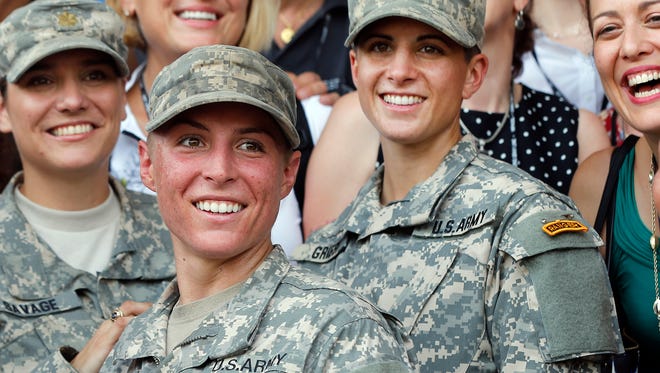 U.S. Army First Lt. Shaye Haver, center, and Capt. Kristen Griest, right, pose for photos with other female West Point alumni after an Army Ranger school graduation ceremony on Aug. 21, 2015, at Fort Benning, Ga.