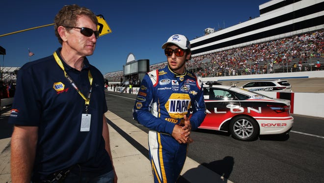 Former driver Bill Elliott and son Chase walk on pit road before the NASCAR Nationwide Series Dover 200 at Dover International Speedway.