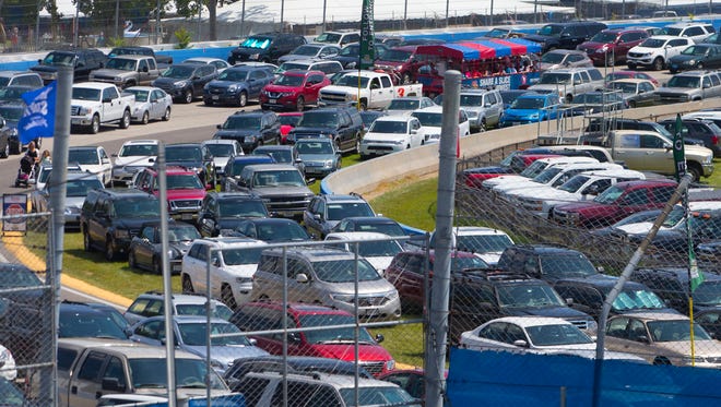 Cars are parked on the Milwaukee Mile racetrack at  State Fair Park. Each day during the fair, about 7,000 cars are parked there and turned over three times a day.