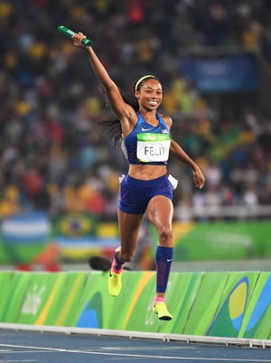 Allyson Felix crosses the finish line in the 4x400 relay.