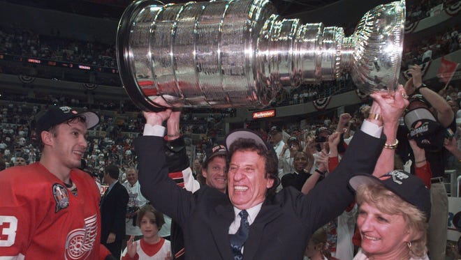 Mike and Marian Ilitch hoist the Stanley Cup on June 16, 1998 in Washington, D.C. after the Red Wings won their second consecutive NHL title by sweeping the Capitals. Igor Larionov is at left.