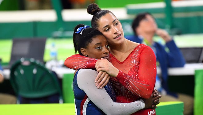 USA gymnasts Simone Biles (left) and Aly Raisman finished first and second, respectively, in the all-around competition.