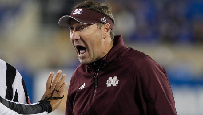 Mississippi State Bulldogs head coach Dan Mullen reacts to a call during the game against the Kentucky Wildcats in the first half at Commonwealth Stadium.