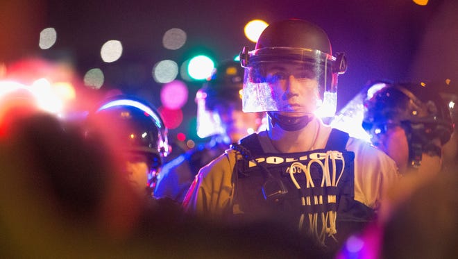 Police officers on the streets of Ferguson, Mo., during protests on Aug. 9, 2015, marking the anniversary of Michael Brown's death.