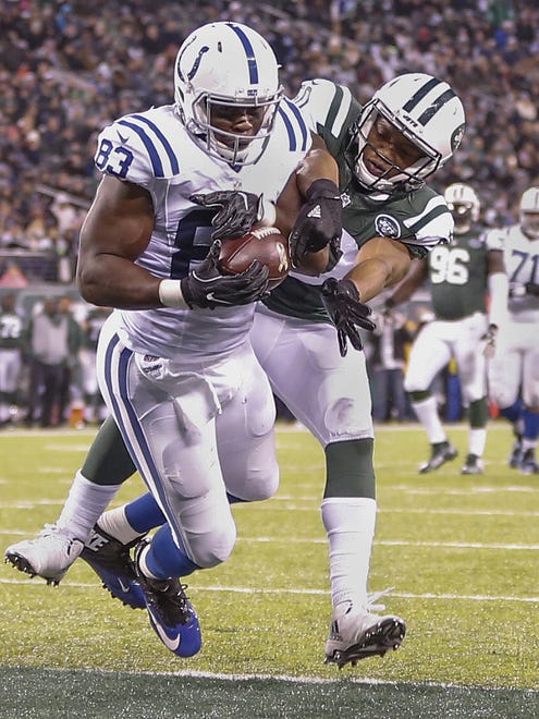 Indianapolis Colts tight end Dwayne Allen (83) catches a 23 yard touchdown from quarterback Andrew Luck (12) while being defended by New York Jets outside linebacker Darron Lee (50) during the second quarter at MetLife Stadium in East Rutherford, N.J., on Monday, Dec. 5, 2016. The touchdown was Allen's 3rd of the 1st half.