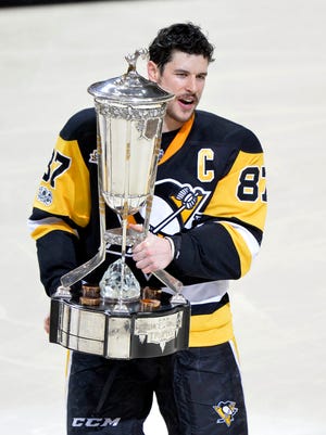 Pittsburgh Penguins center Sidney Crosby skates off of the ice with the Prince of Wales Trophy after beating the Ottawa Senators in double overtime of Game 7.