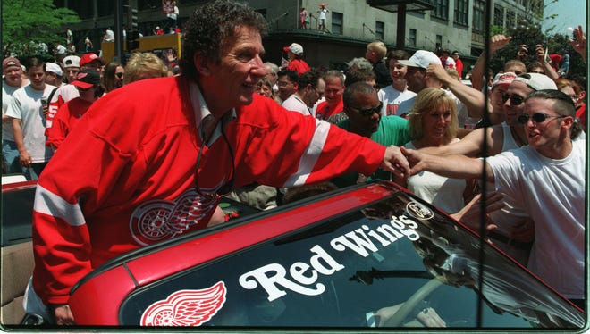 In 1997, Mike Ilitch shakes hands with the parade goers down Woodward Ave. after winning the Stanley Cup.