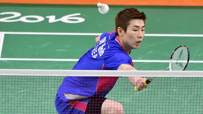 Wan Ho Son of South Korea stretches to return a shot to Artem Pochtarov of Ukraine during badminton men's singles group stage play in the Rio 2016 Summer Olympic Games at Riocentro - Pavilion 4.