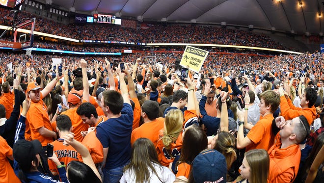 Syracuse Orange fans celebrate on the court.