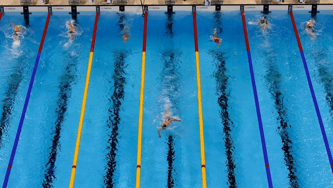 Katie Ledecky, shown leading the 800 freestyle, won the event by 11 seconds and set a world record.