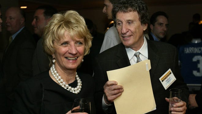 Detroit Red Wings and Detroit Tigers owner Mike Ilitch smiles with his wife Marian, during induction ceremonies for the Michigan Sports Hall of Fame in Detroit, Tuesday, March 30, 2004.