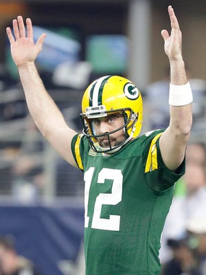 Green Bay Packers quarterback Aaron Rodgers (12) celebrates after a touchdown during the second quarter against the Dallas Cowboys in the NFC Divisional playoff game at AT&T Stadium.