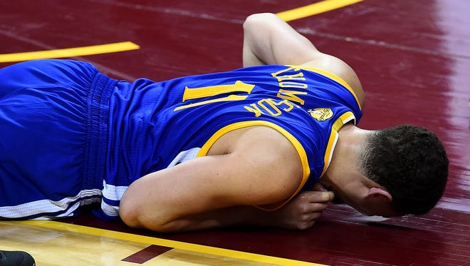 Golden State Warriors guard Klay Thompson (11) reacts after being injured during the first quarter against the Cleveland Cavaliers in Game 3 of the NBA Finals at Quicken Loans Arena.