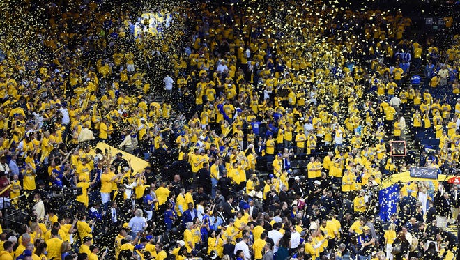 Confetti falls as spectators celebrate the Golden State Warriors 104-89 victory against Cleveland Cavaliers following game one of the NBA Finals at Oracle Arena.
