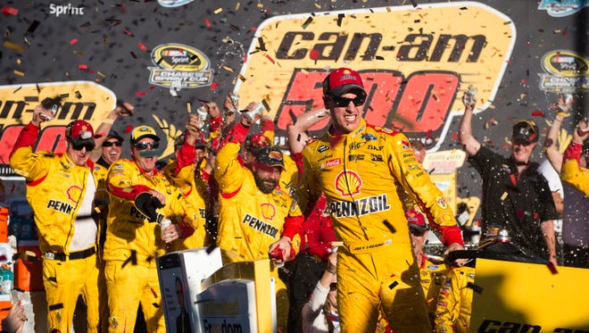 Round 3: Joey Logano, center, celebrates with his crew after winning at Phoenix International Raceway on Nov. 13 and securing an automatic berth for the championship race.