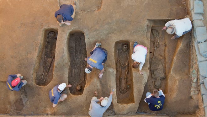 Overview of the chancel burial excavations. Archaeologists (from left to right) Mary Anna Richardson, Danny Schmidt, David Givens, Dan Smith, Don Warmke, Jamie May, Dan Gamble, and Dr. William Kelso. Photo by Michael Lavin,