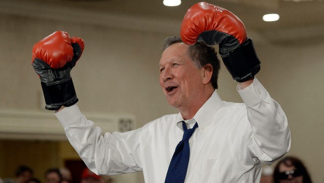 Kasich dons a pair of boxing gloves during a campaign stop at the Crowne Plaza on April 19, 2016, in Annapolis, Md.