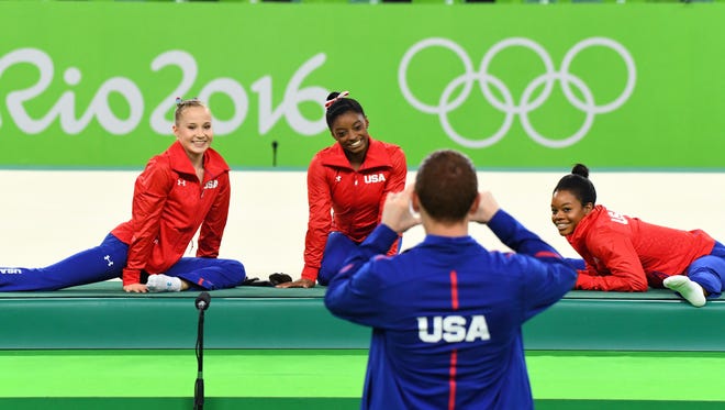 USA gymnasts Madison Kocian, left, Simone Biles, center, and Gabby Douglas pose for a picture before the women's individual event finals in the Rio 2016 Summer Olympic Games at Rio Olympic Arena.