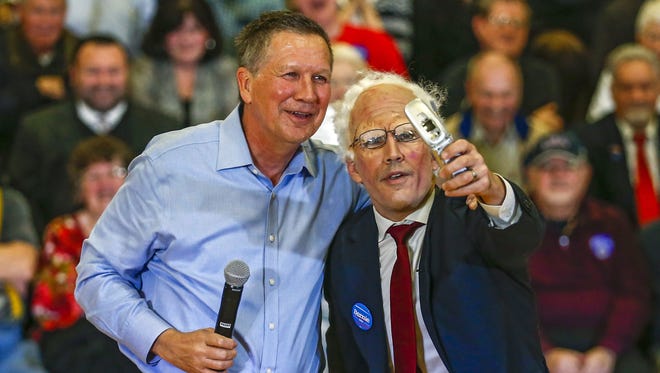Kasich poses for a selfie with a Bernie Sanders impersonator at a campaign event at the Palatine Park District Community Center Gymnasium in Palatine, Ill., on March 9, 2016.