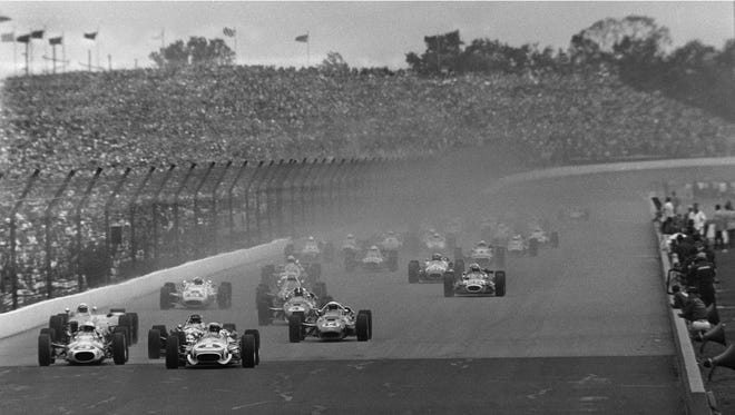 Mario Andretti (1) leads the field at the start of the 51st running of the Indianapolis 500 at Indianapolis Motor Speedway May 30, 1967. The race had to be stopped for rain, and was restarted the following day. At far left is Gordon Johncock (3), and at center is A.J. Foyt (14), the eventual race winner. (AP Photo)