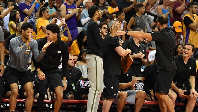 Los Angeles Lakers players celebrate on the bench after the Lakers defeated the Portland Trail Blazers in the NBA Summer League final.