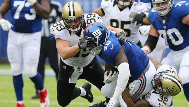 New Orleans Saints defensive end Paul Kruger (99) and Kenny Vaccaro (32) tackle New York Giants' Will Tye (45) during the first half of an NFL football game Sunday, Sept. 18, 2016, in East Rutherford, N.J.  (AP Photo/Seth Wenig) ORG XMIT: ERU110