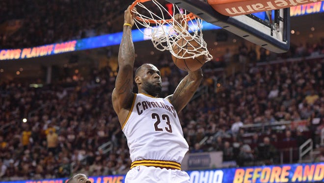 Cleveland Cavaliers forward LeBron James (23) dunks the ball in front of Golden State Warriors forward Draymond Green (23) during the four quarter in Game 3 of the NBA Finals at Quicken Loans Arena.