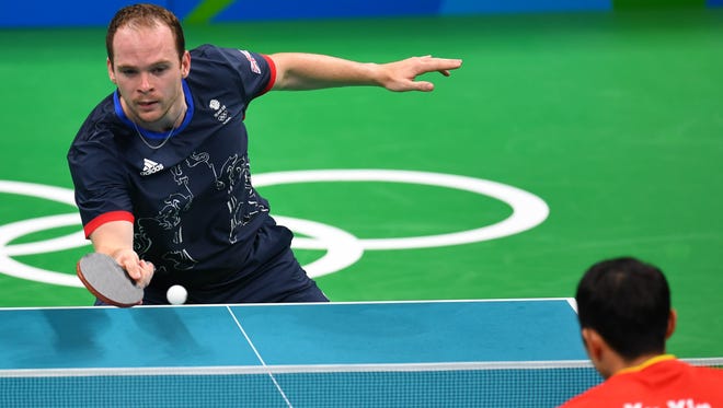 Paul Drinkhall of Great Britan competes against Xin Xu of China in a table tennis match at Riocentro - Pavilion 3 during the Rio 2016 Summer Olympic Games.