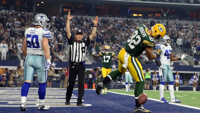 Green Bay Packers tight end Richard Rodgers (82) reacts after scoring a touchdown against Dallas Cowboys outside linebacker Sean Lee (50) during the first quarter in the NFC Divisional playoff game at AT&T Stadium.