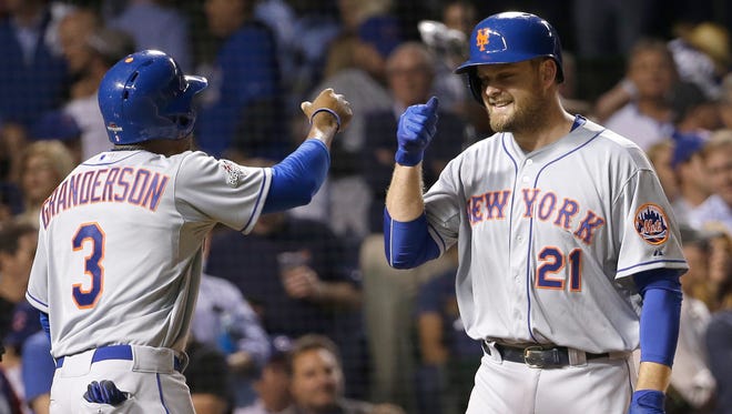 New York Mets' Lucas Duda is congratulated by Curtis Granderson after hitting a three-run home run during the first inning of Game 4 of the National League baseball championship series against the Chicago Cubs Wednesday, Oct. 21, 2015, in Chicago.
