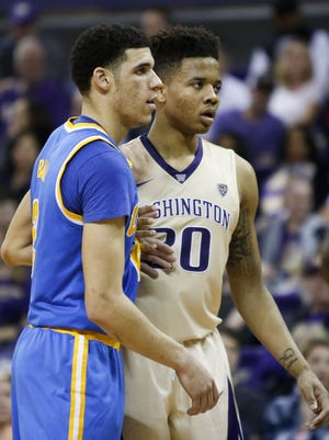 Lonzo Ball and Markelle Fultz guard each other during a game at Alaska Airlines Arena.