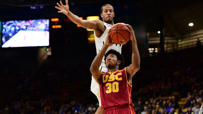 Colorado Buffaloes guard Josh Fortune (44) defends on USC Trojans guard Elijah Stewart (30) n the first half at the Coors Events Center.