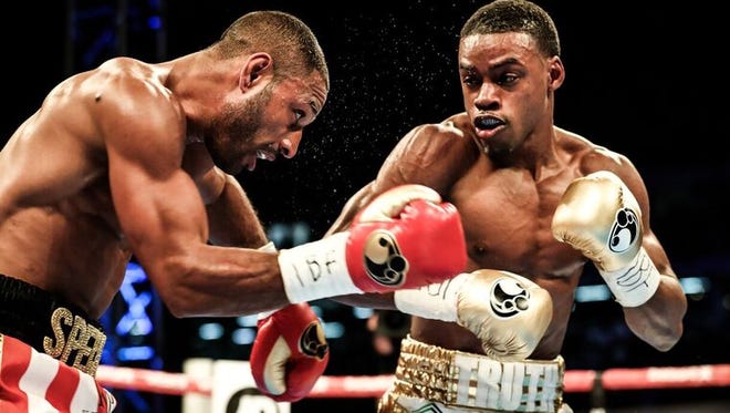 Errol Spence Jr., left, connects against Kell Brook on Saturday night.