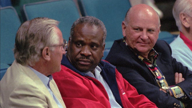 Thomas and Florida Panthers owner Wayne Huizenga, right, listen to former Miami Dolphins coach Don Shula during a break in the Florida Panthers-St. Louis Blues hockey game at the Miami Arena on Feb. 11, 1996.
