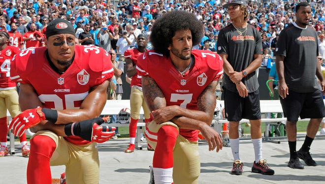 Colin Kaepernick and Eric Reid kneel during the national anthem prior to Sunday's game.