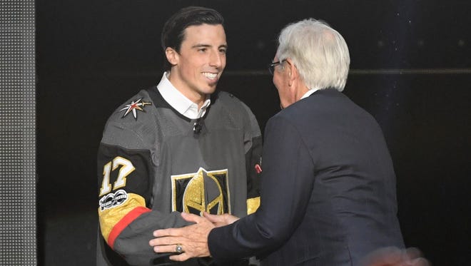 Goaltender Marc-Andre Fleury shakes hands with Vegas Golden Knights owner Bill Foley during the expansion draft.