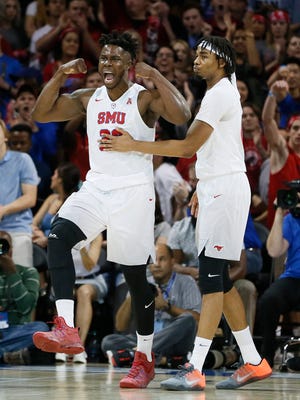 Southern Methodist Mustangs forward Semi Ojeleye (33) and forward Ben Moore (00) react to a basket in the first half against the Cincinnati Bearcats at Moody Coliseum.
