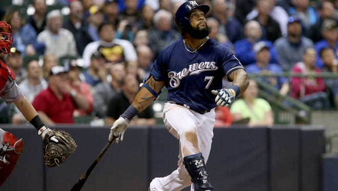 The Brewers' Eric Thames hits a home run in the sixth inning against the Cincinnati Reds at Miller Park on Tuesday.