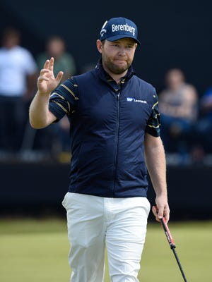 Branden Grace reacts after making a birdie putt on the 14th green during the third round of The 146th Open Championship.