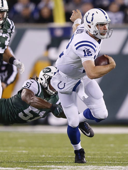 Indianapolis Colts quarterback Andrew Luck (12) carries for a first down past New York Jets inside linebacker Julian Stanford (51) during the second half at MetLife Stadium in East Rutherford, N.J., on Monday, Dec. 5, 2016.