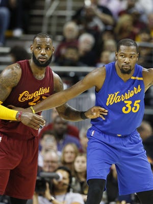 Golden State Warriors forward Kevin Durant (35) defended by Cleveland Cavaliers forward LeBron James (23) at Quicken Loans Arena.