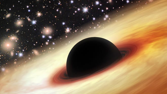 A massive black hole whose mass is 12 billion times that of our sun's is believed to be found by scientists billions of light years from Earth. (Image is an artist's impression of a black hole.)