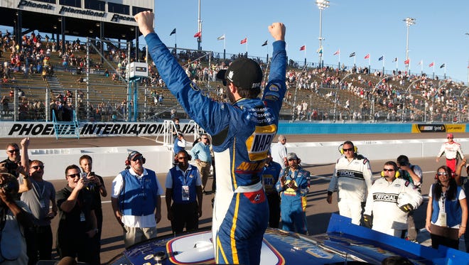 Chase Elliott celebrates with fans after winning the NASCAR Nationwide Championship after finishing fifth in the Nationwide Series auto race at Phoenix International Raceway Saturday, Nov. 8, 2014, in Avondale, Ariz.