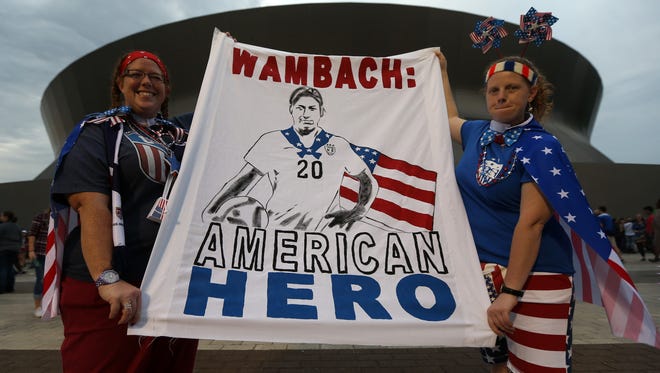 A pair of fans show off their Wambach banner before the game.