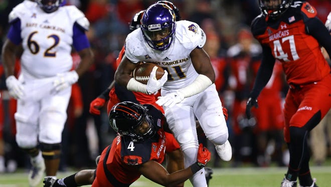 East Carolina wide receiver James Summers (11) is tackled by Cincinnati safety Zach Edwards (4) in the second half.